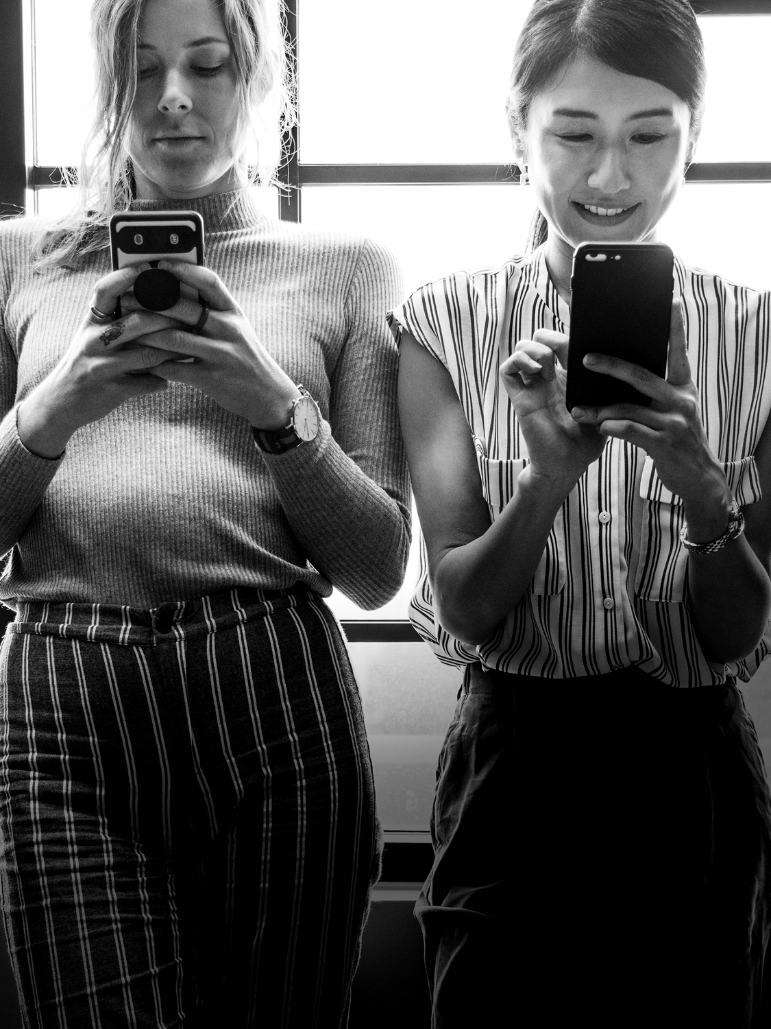 Two females on their phones